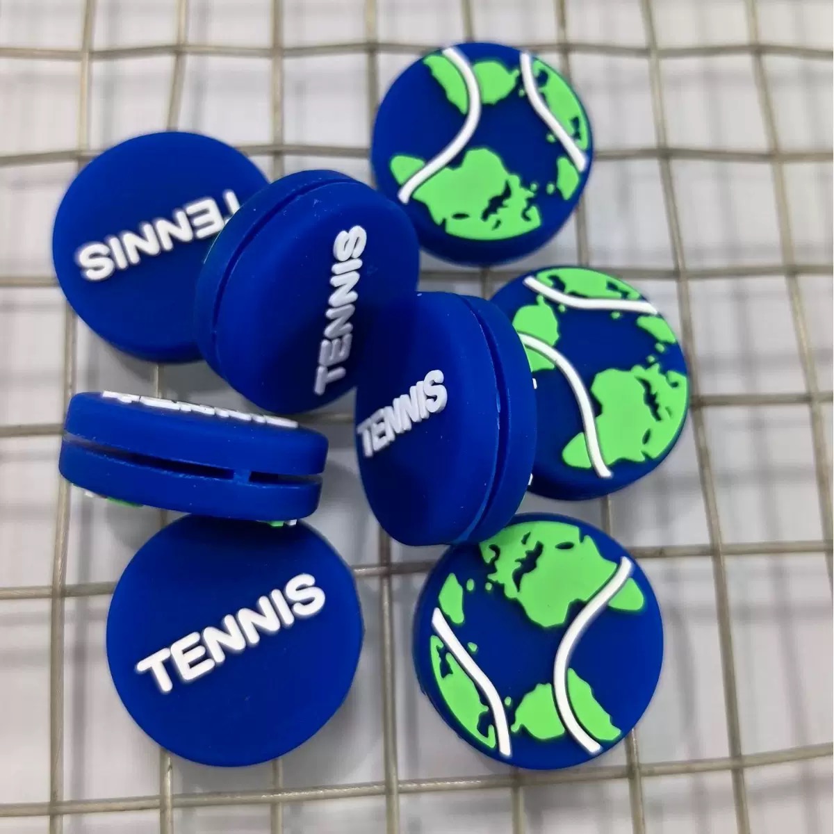 Round silicone tennis dampeners with a custom tennis graphic