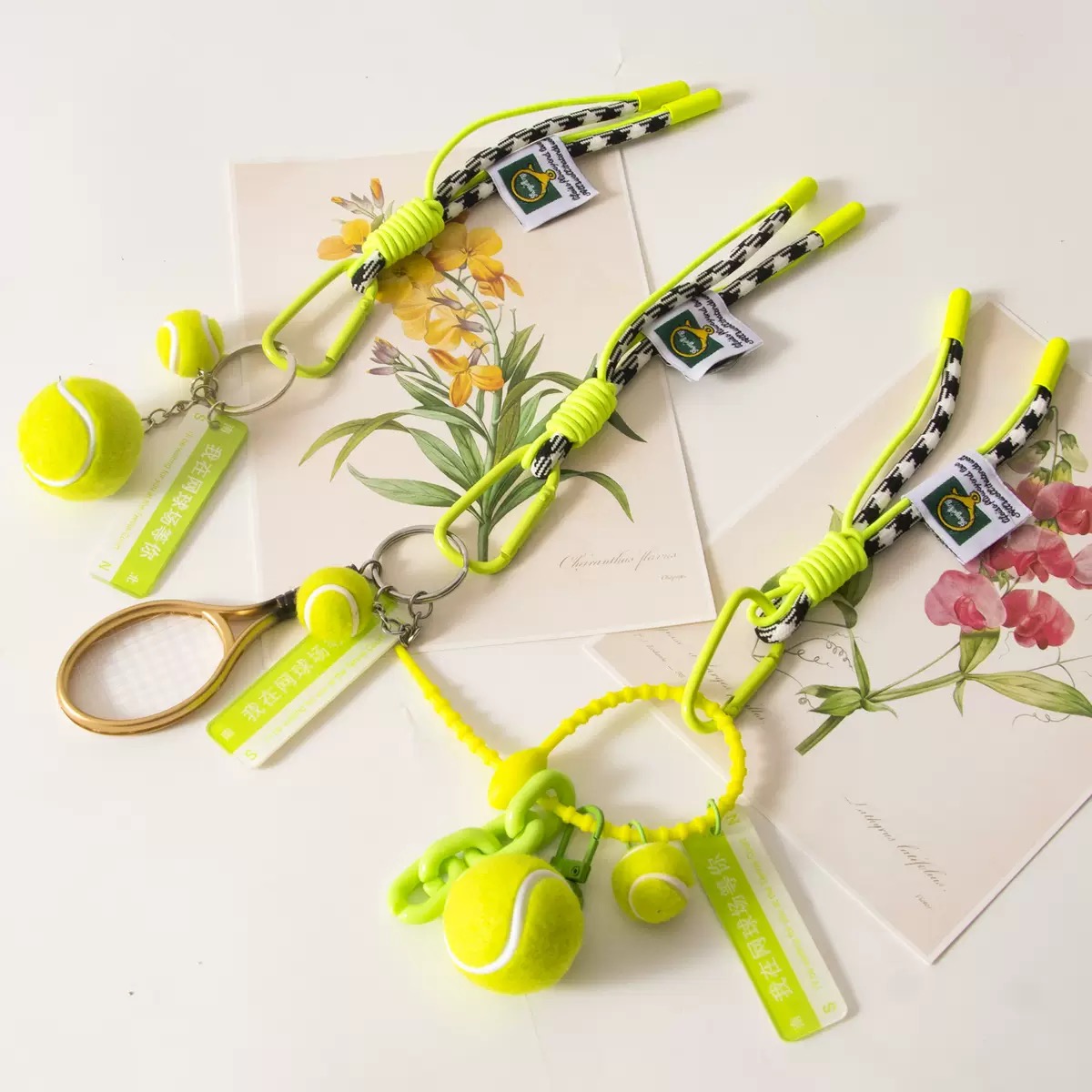 Color-coordinated tennis-themed keychain accessory set