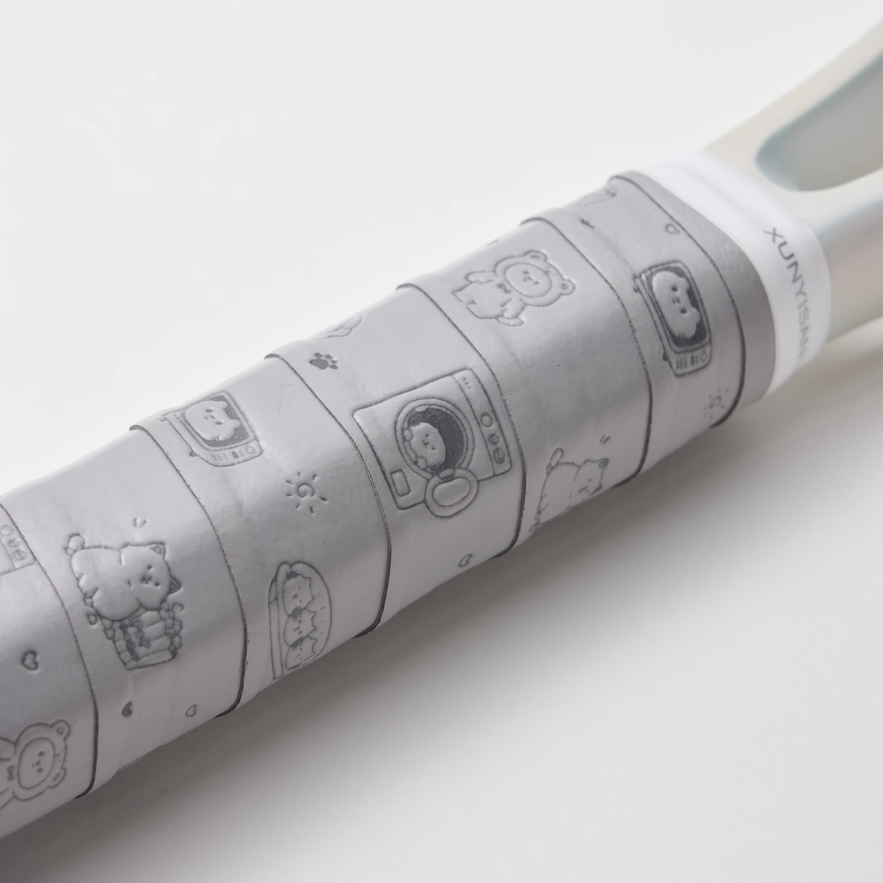 Close-up of a white overgrip with embossed custom pattern